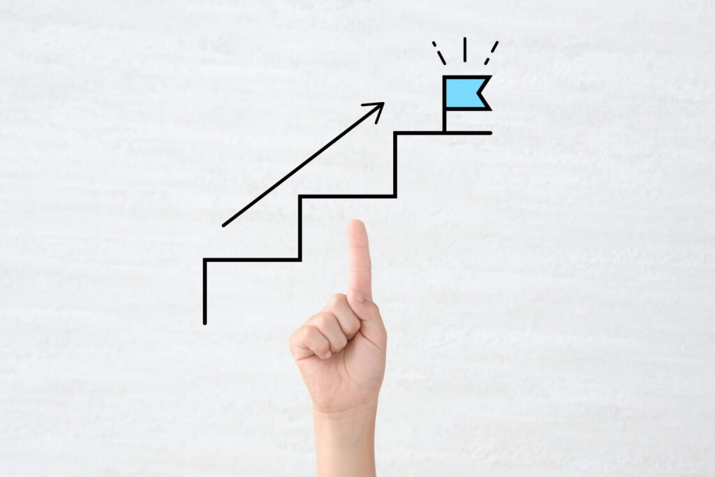 子供の手と旗の建てられたステップの合成画像